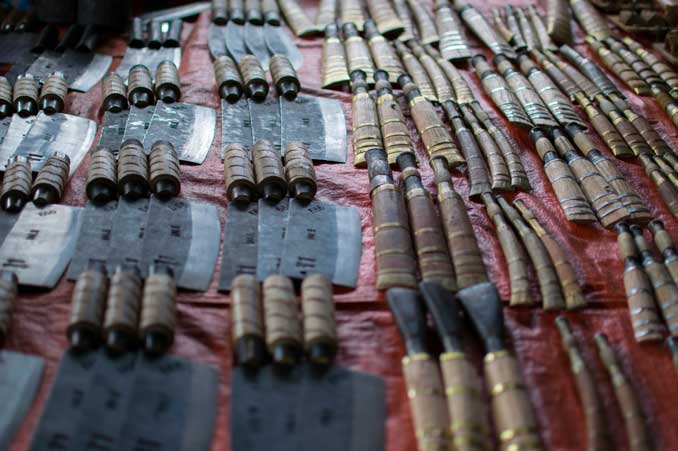 Assortment of knives on display at market.