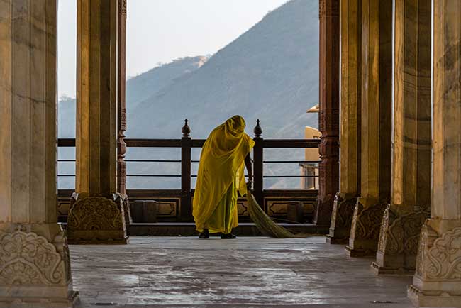 Woman sweeping inside Amber Fort.