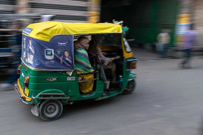 Panning shot of tuk-tuk.