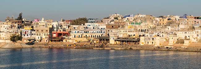 Buildings along Pushkar lake in later afternoon light.