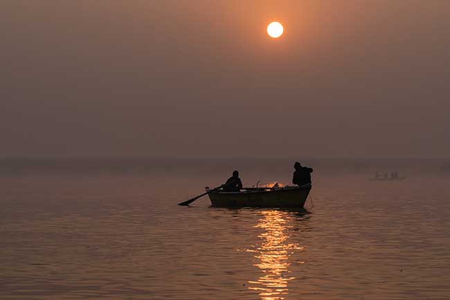 Boat under the rising sun.