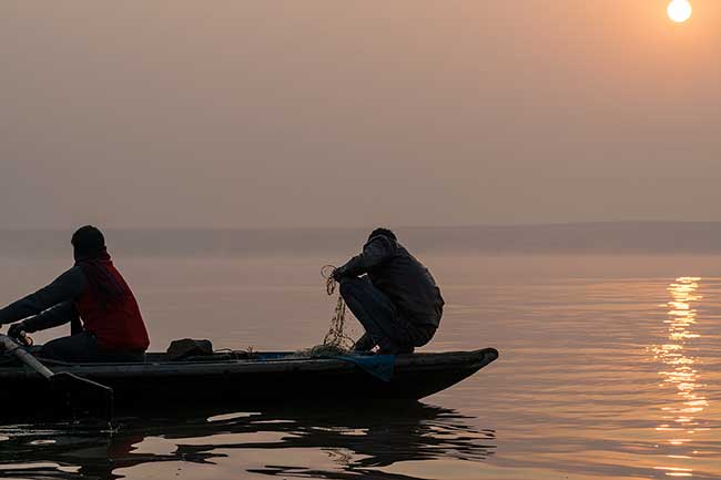 Two fishermen at sunrise.